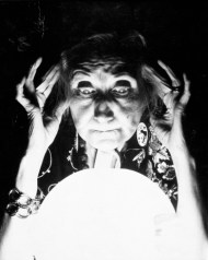 OLD FORTUNE TELLER GAZES INTO CRYSTAL BALL