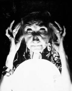 OLD FORTUNE TELLER GAZES INTO CRYSTAL BALL